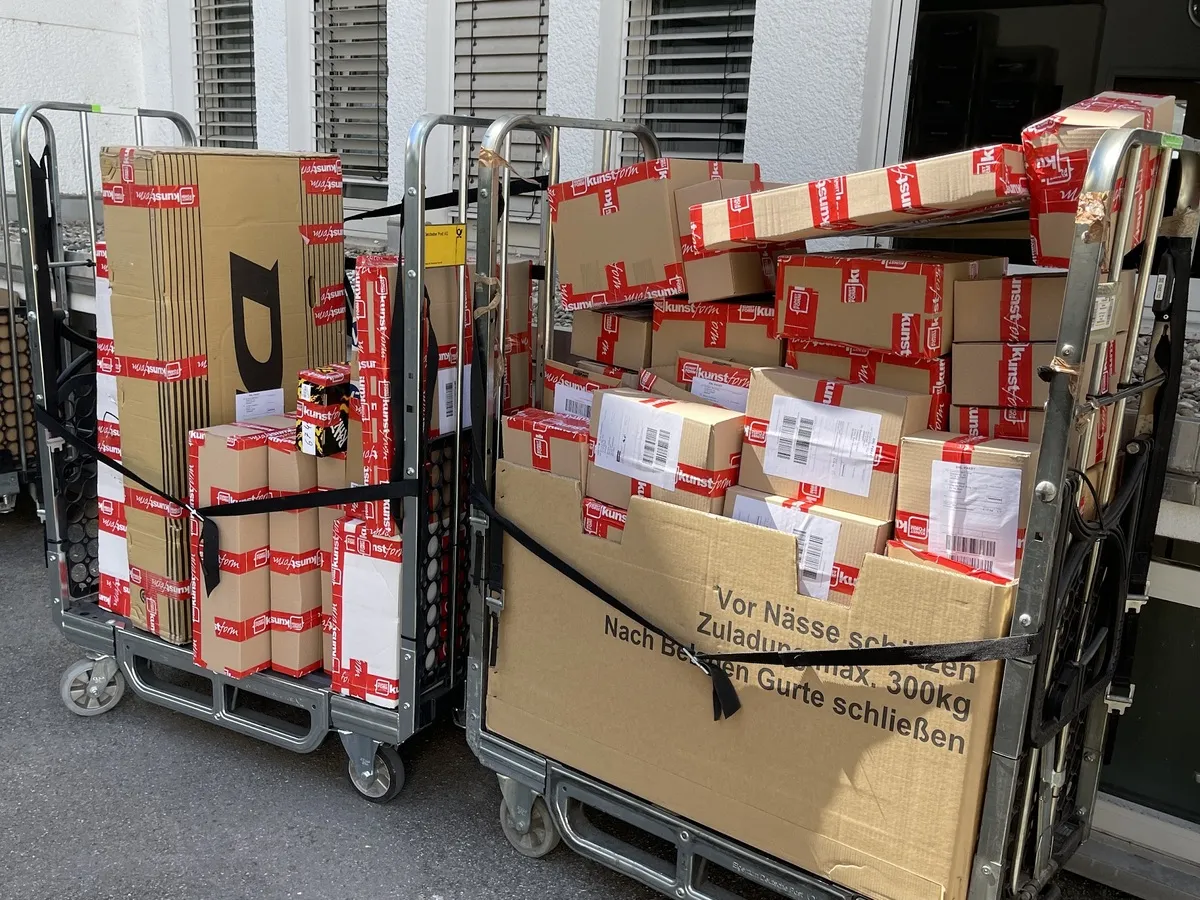 Trolleys with finished parcels in front of the building