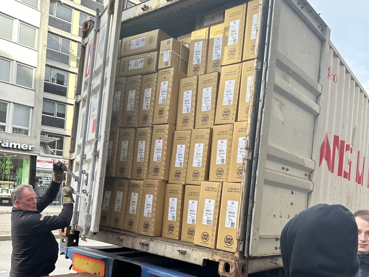 A trailer loaded to the roof with cartons being unloaded