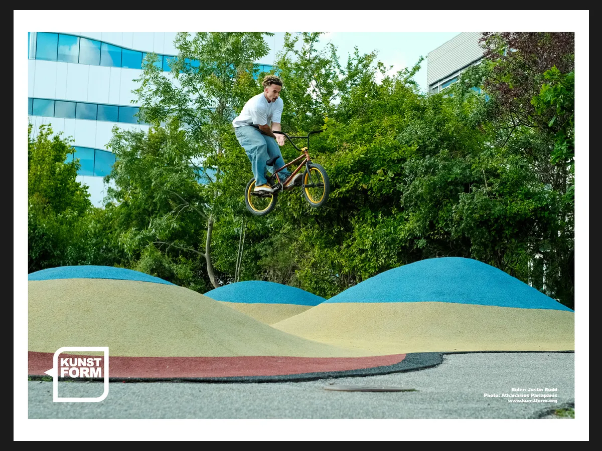 Team poster 2024, Copenhagen: Justin Rudd over the rollers of a pumptrack
